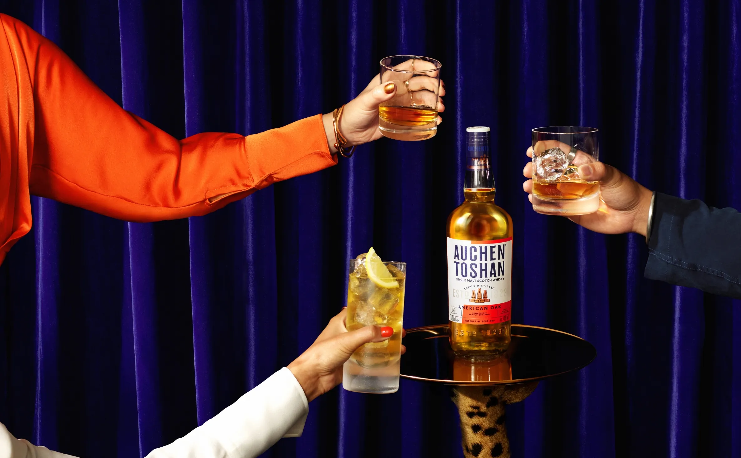 Whiskey glasses toast blue curtain auchentoshan